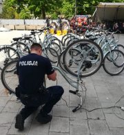 umundurowany policjant grawerujący numer na rowerze